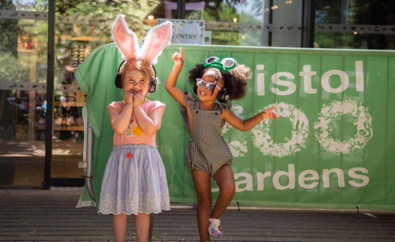 Two children wearing headphones and animal ears at Bristol Zoo